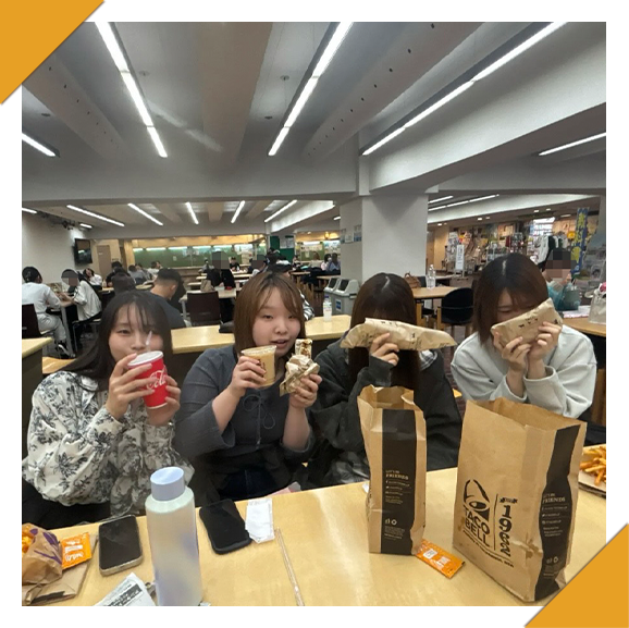 学食で長谷川さんが友達みんなでランチタイムを楽しんでいる写真